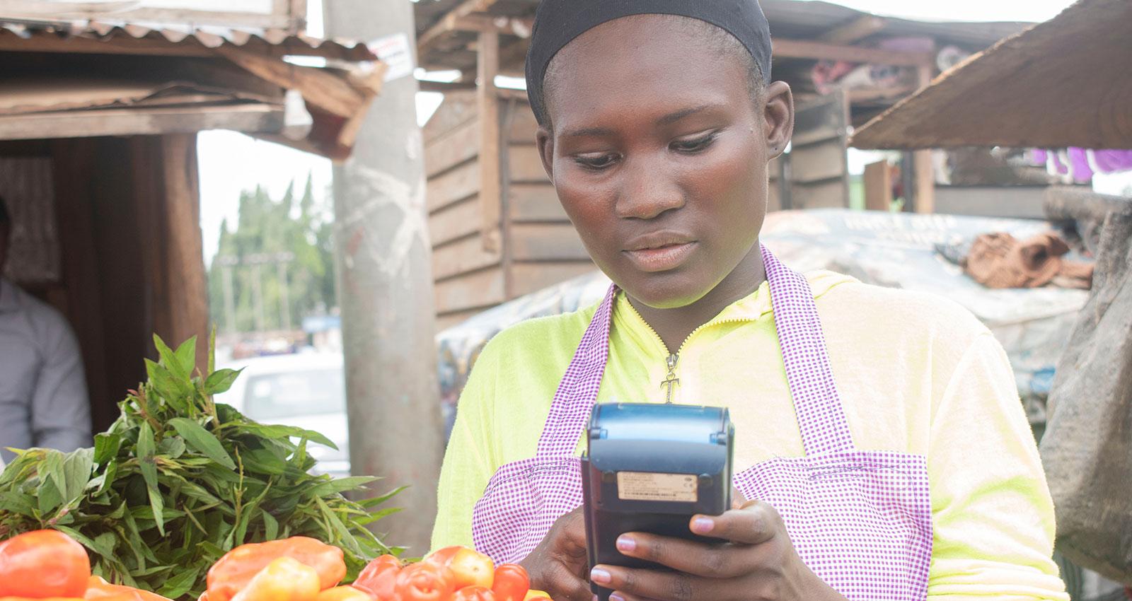 An african lady using a point of sale device