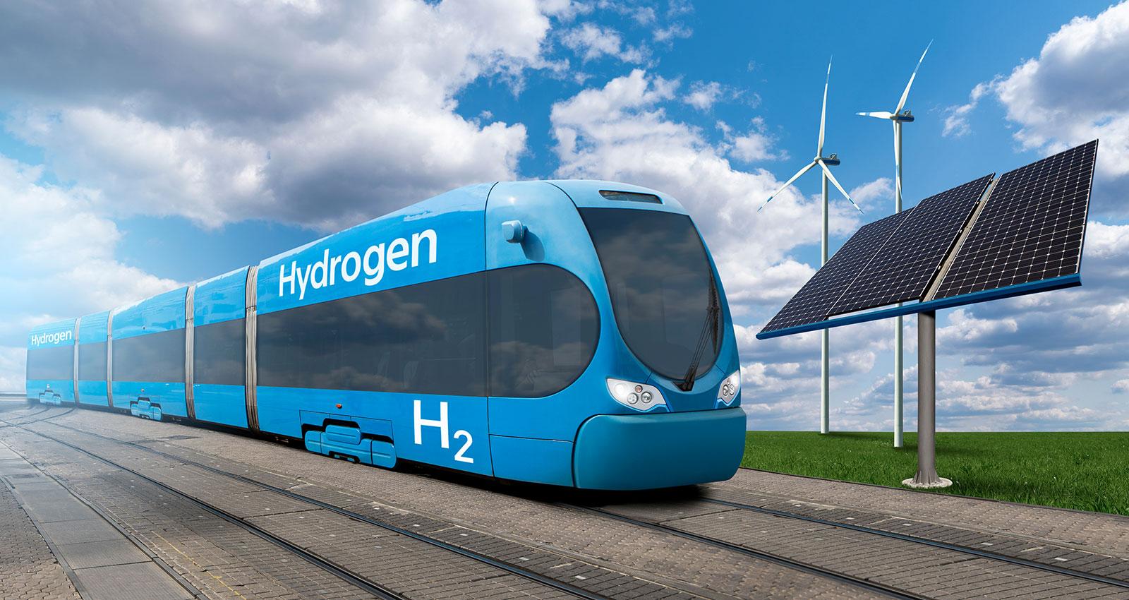 Train powered by hydrogen with wind turbines and solar panels. Getting green hydrogen from renewable energy sources.