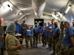 Medical professionals assigned to the 531st Hospital Center conduct an after-action review following the mass casualty scenario outside the operation room of the field hospital at Sierra Army Depot, California, on Oct. 28, 2019. (image credit: Spc. ShaTyra Reed/Army) Note the appearance of U.S. Department of Defense (DoD) visual information does not imply or constitute DoD endorsement.