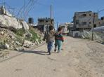 Children walking on road in Gaza